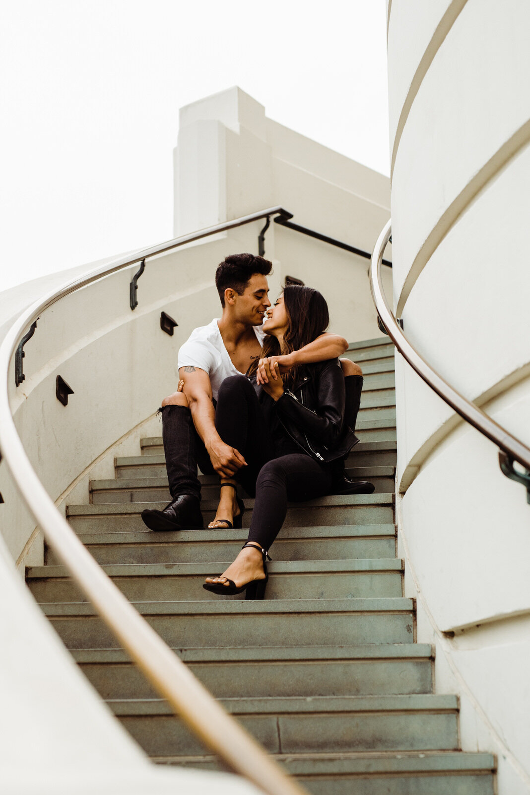 Los Angeles Engaged Couple sit on the staircase at Griffith Observatory 