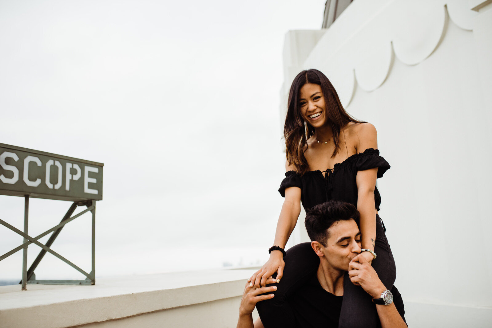 Dark and moody engagement photos near Griffith Observatory Telescope sign