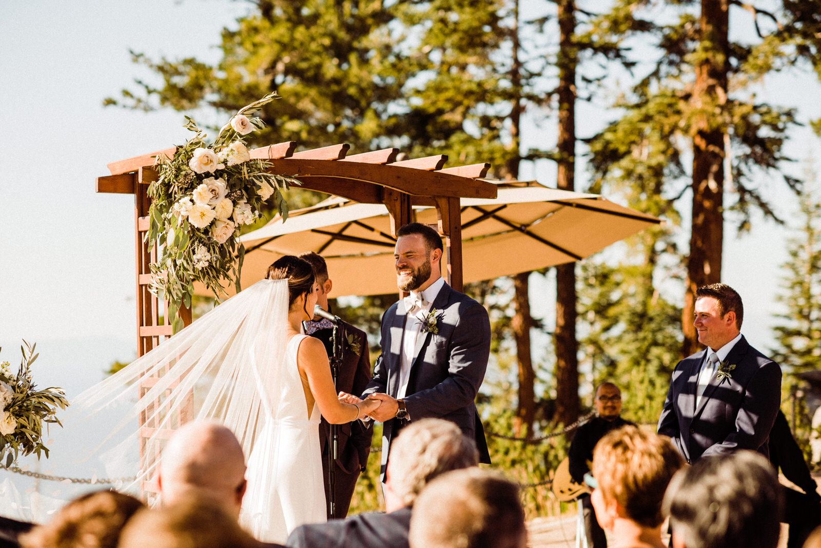 Bride and groom exchange rings at Heavenly Lakeview Lodge August Wedding Ceremony