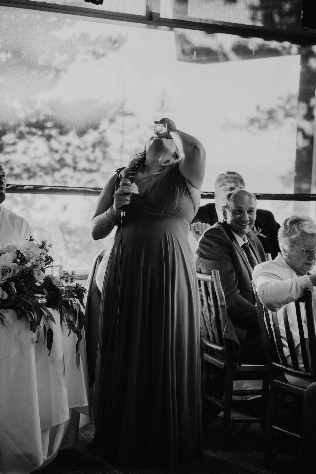 Maid of Honor takes a shot during toast to couple at Heavenly Lakeview Lodge Wedding