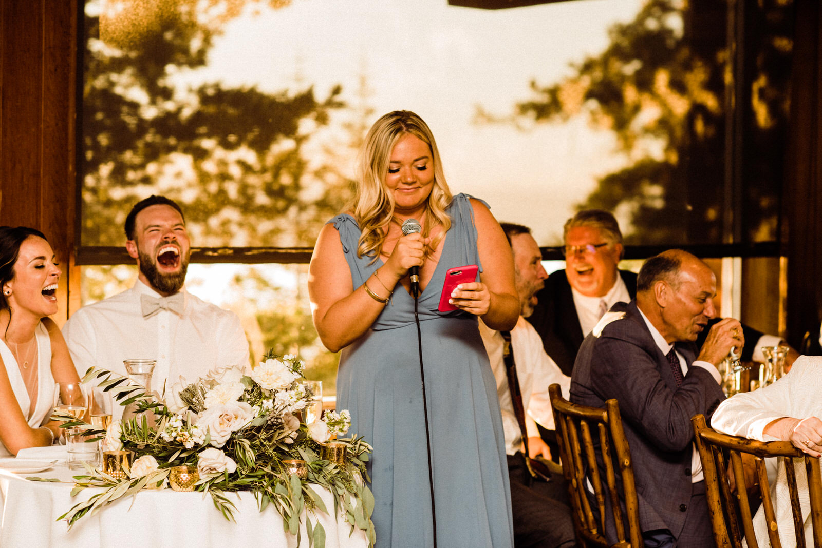 Sister toasts during Heavenly Lakeview Lodge Summer Wedding, Bridesmaid in light blue dress