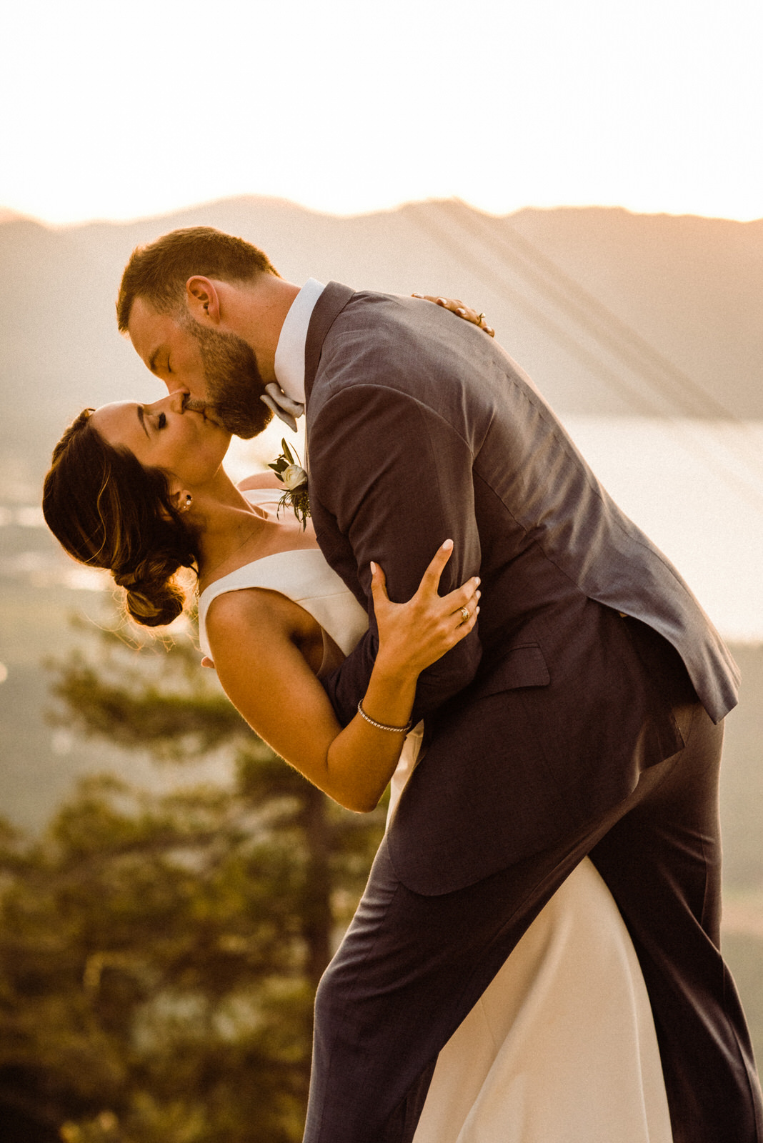 Couple Kisses in front of South Lake Tahoe at Lakeview Lodge Summer Wedding Golden Hour
