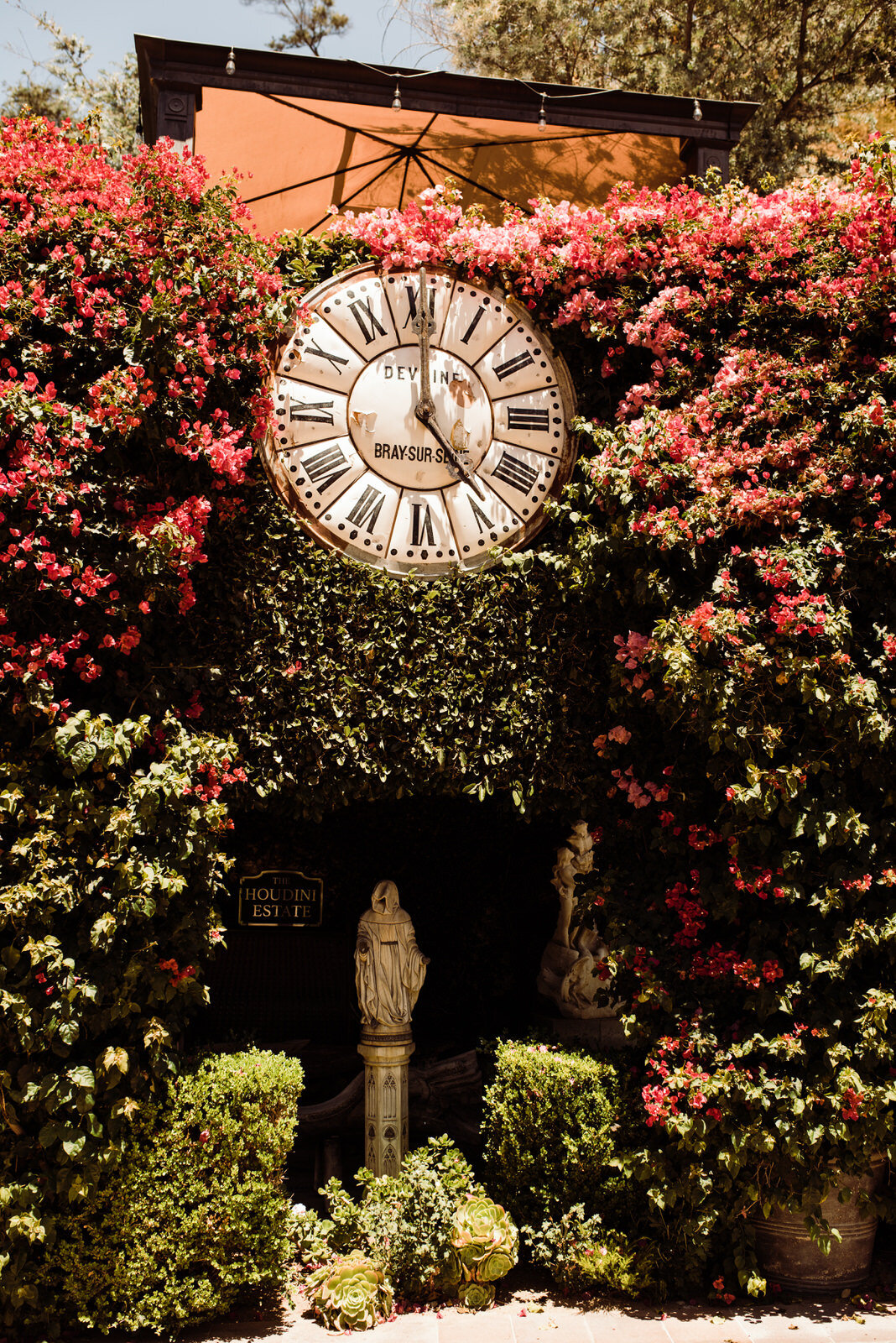 French Wall Clock at Houdini Estate in Laurel Canyon Surrounded by Flowering Pink Bougainvillea | LA Wedding Venue | Laurel Canyon Los Angeles Wedding | Photo by Kept Record | www.keptrecord.com