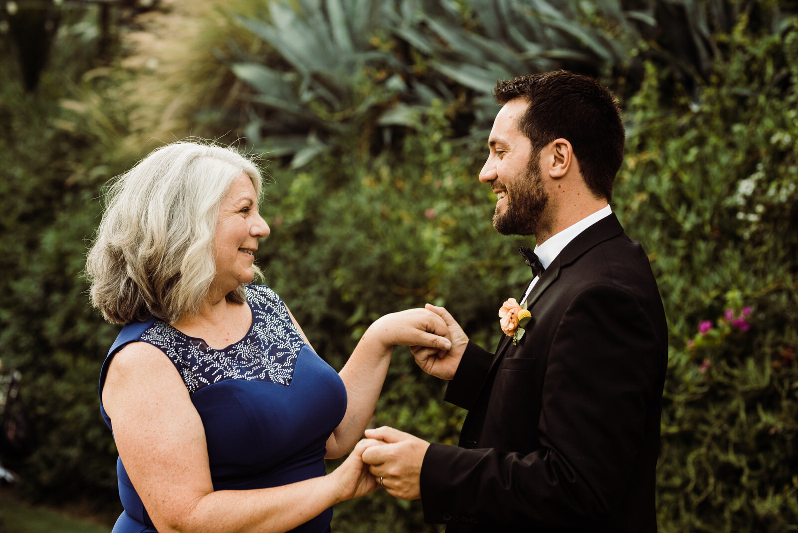 Mother of the groom wearing blue dress dancing 
