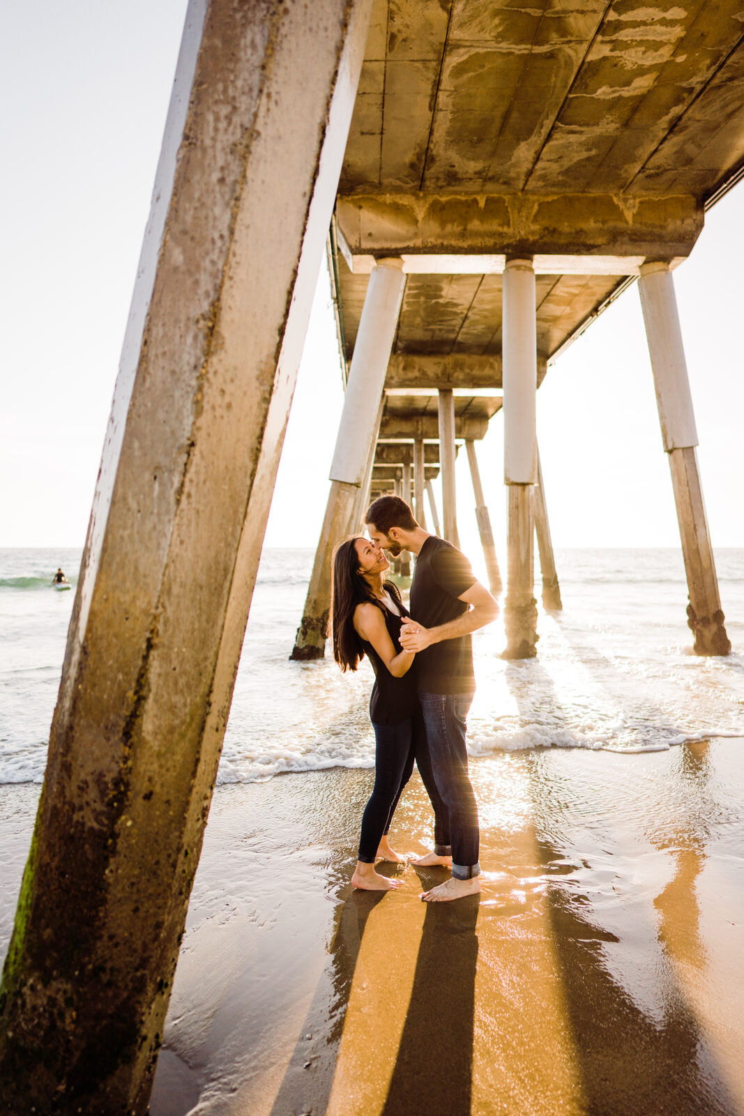 Engaged Couple beneath Hermosa Beach Pier
