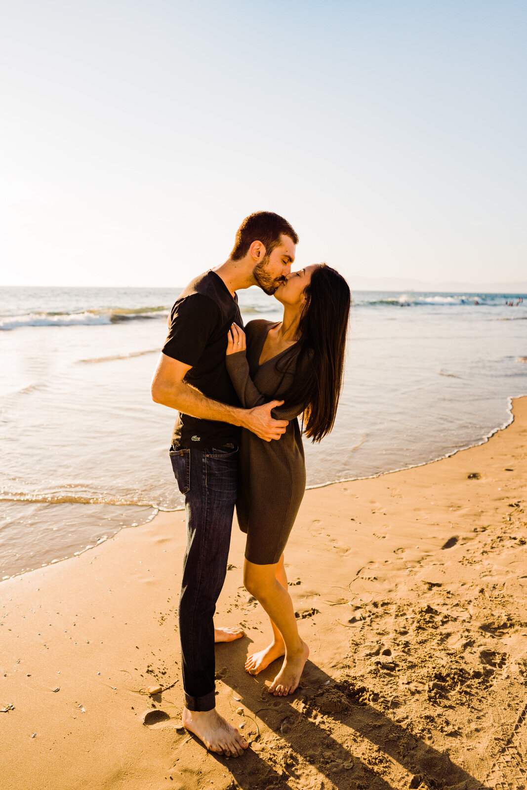 Engaged couple kisses at Hermosa Beach