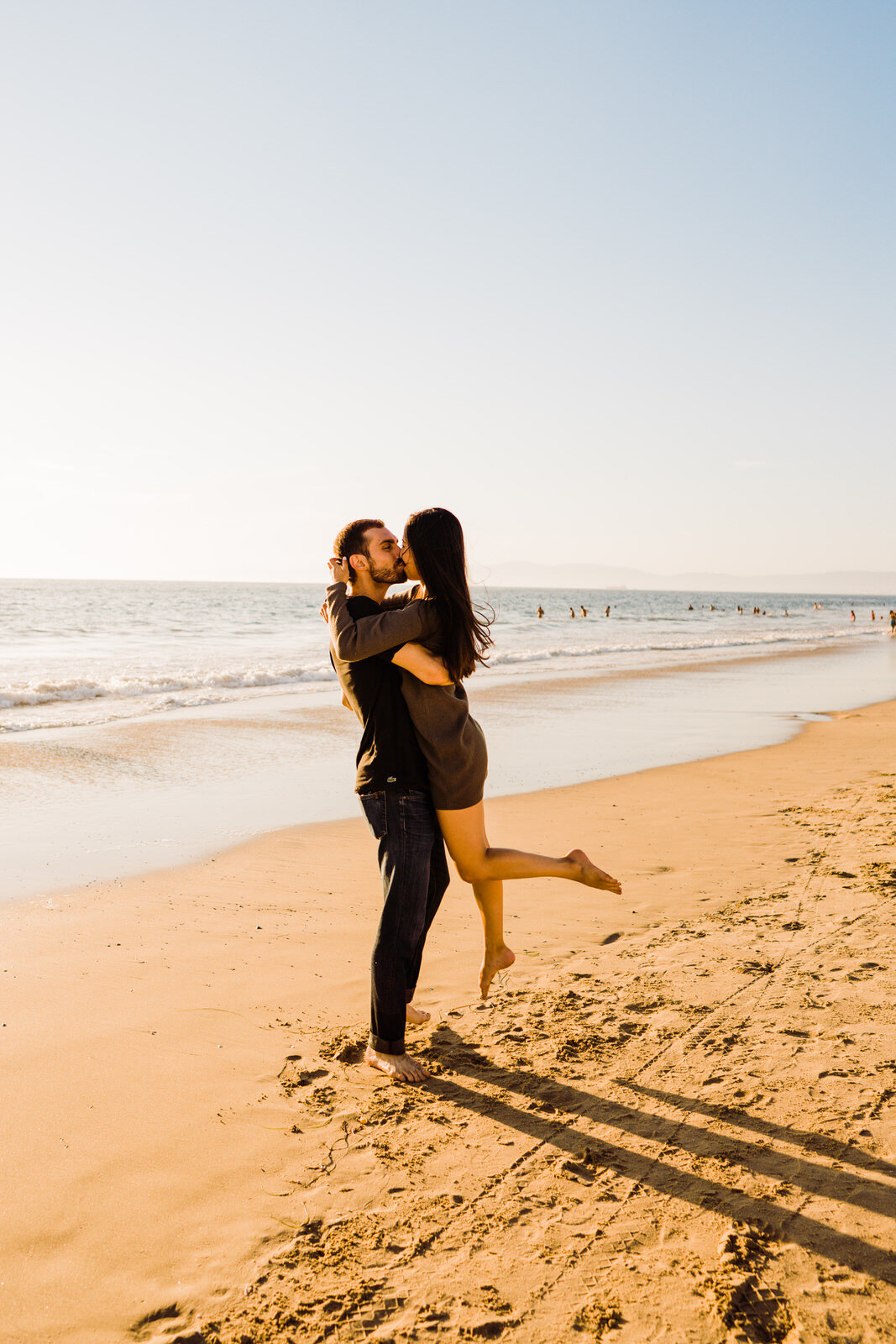 Couple embraces on the sand at Hermosa Beach