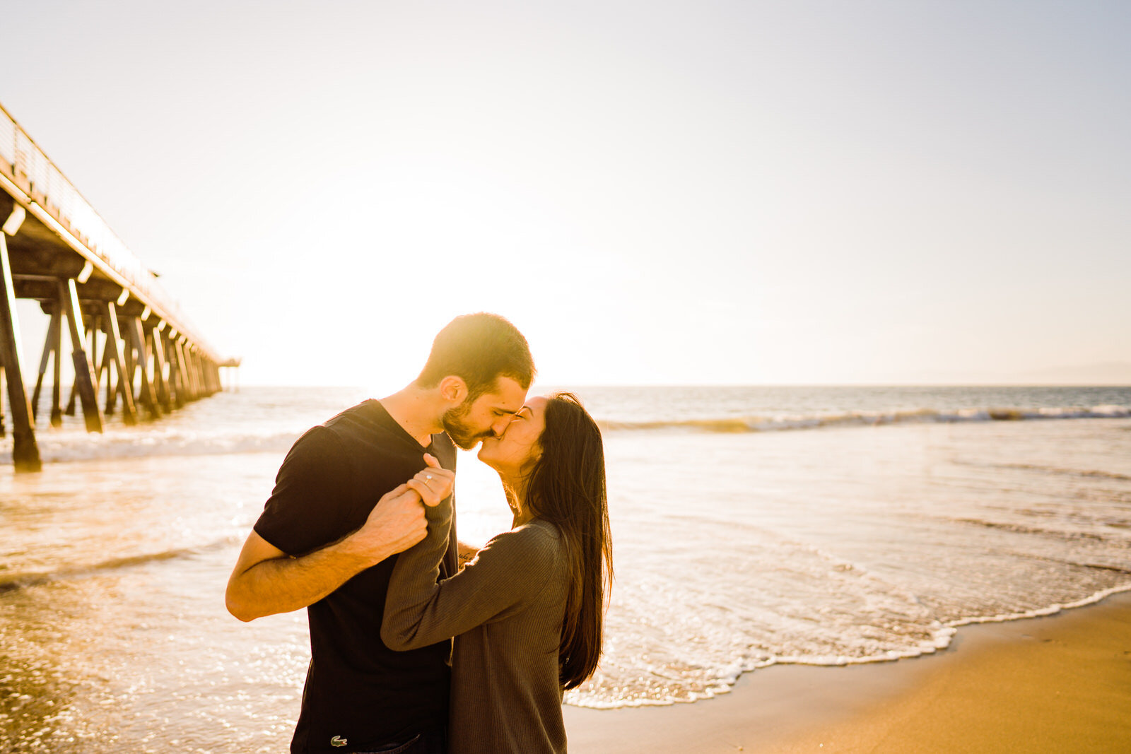 Backlit sunny photo of couple on the sand at Hermosa Beach