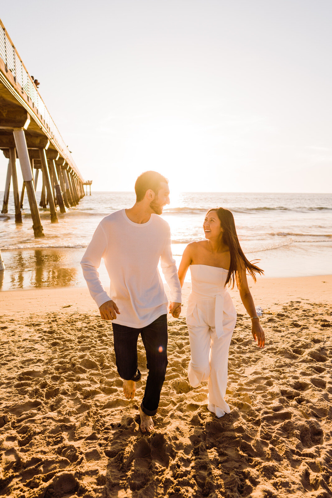 Engaged couple in white on Hermosa Beach