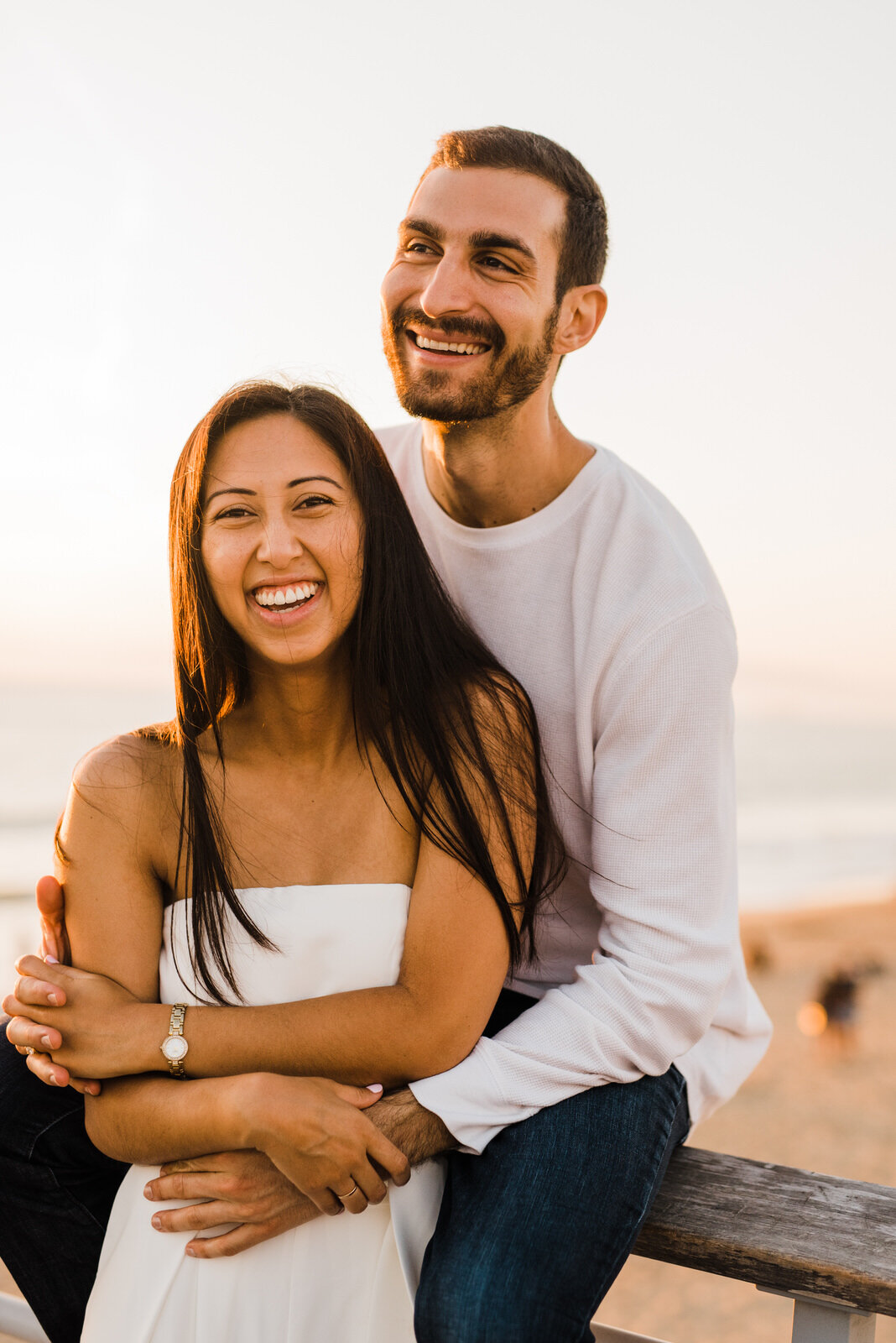 happy fun engagement photos at Hermosa Beach Pier during sunset