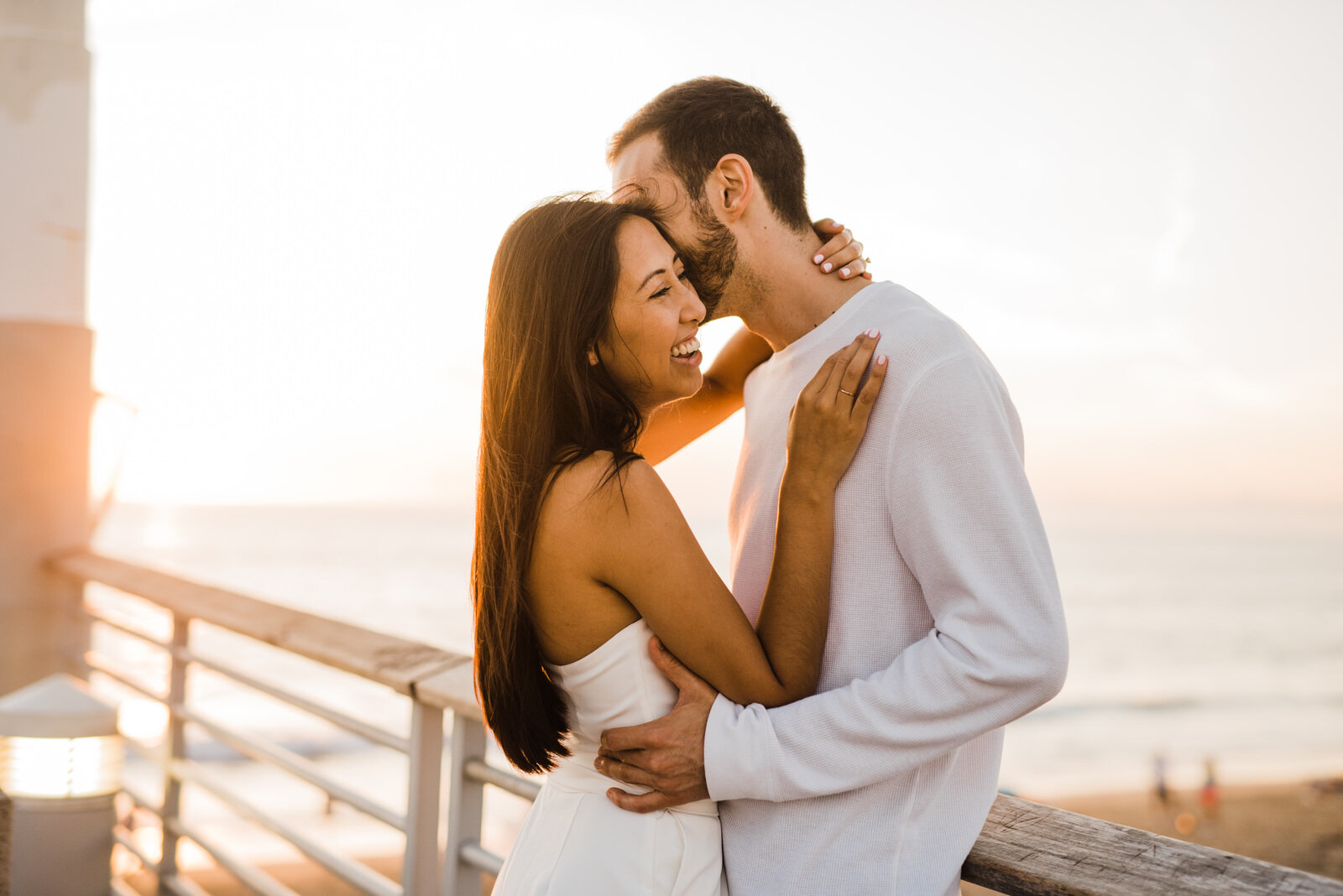 Couple laughs and hugs at Hermosa Beach Pier