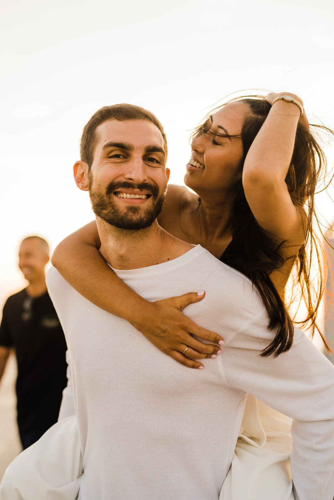 candid piggyback photos of engaged couple