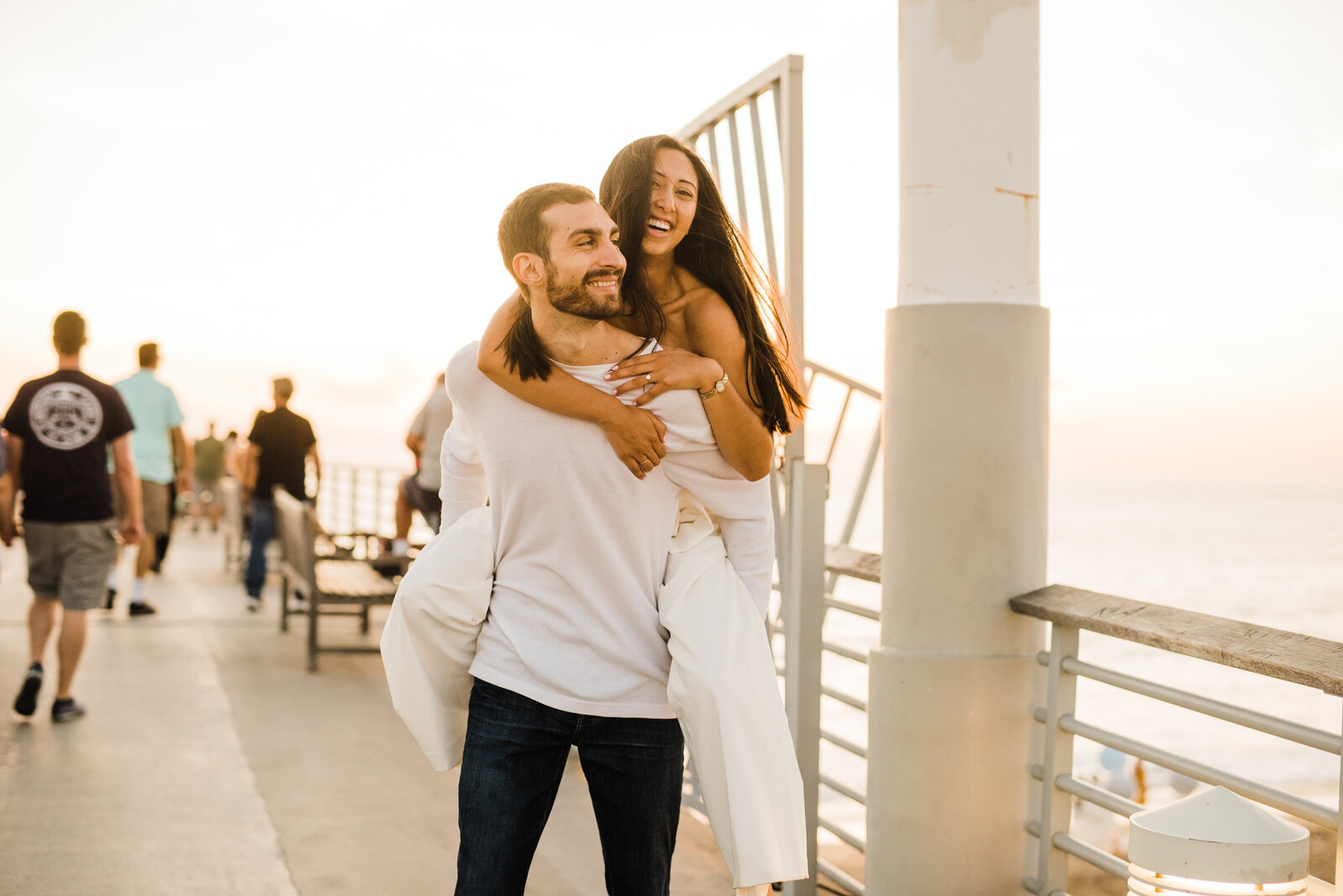 playful, energetic engagement photos at Hermosa Beach Pier