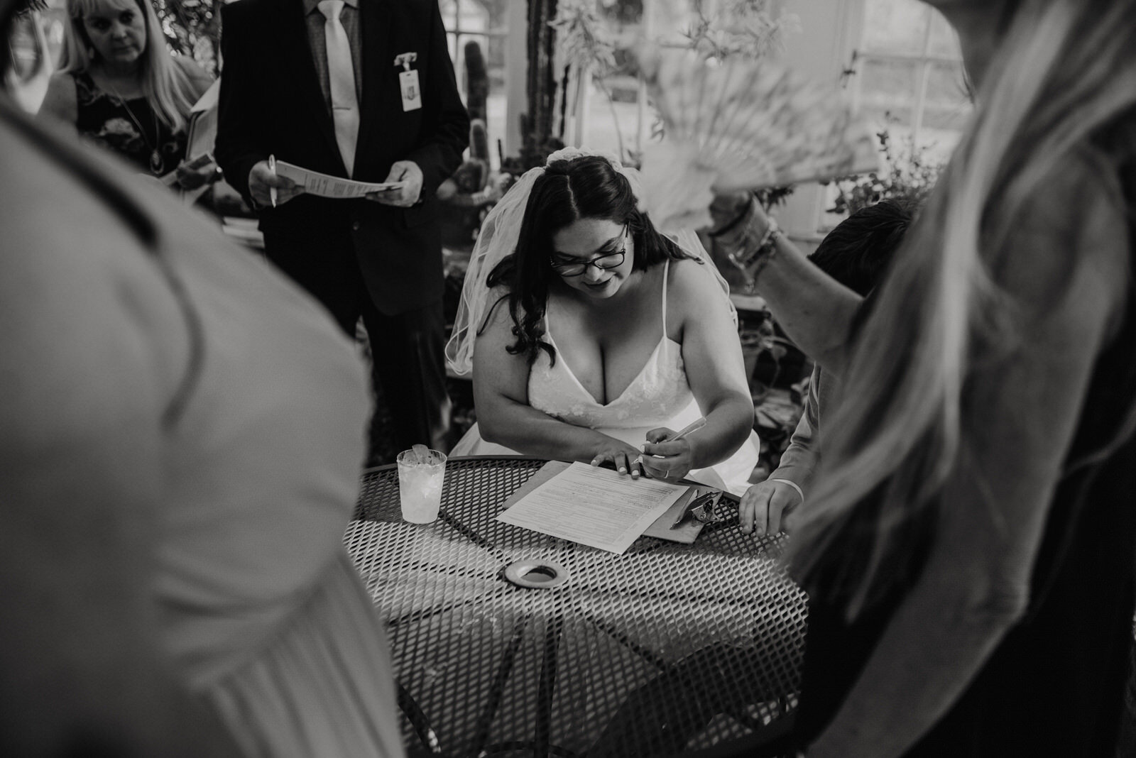 Bride signs marriage license at Santa Fe Springs Heritage Park Plant Conservatory