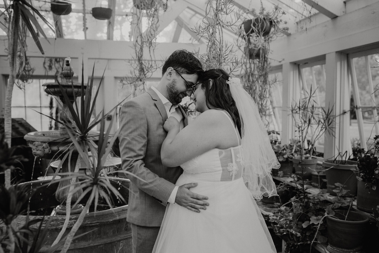 Couple photos in plant conservatory at Heritage Park 