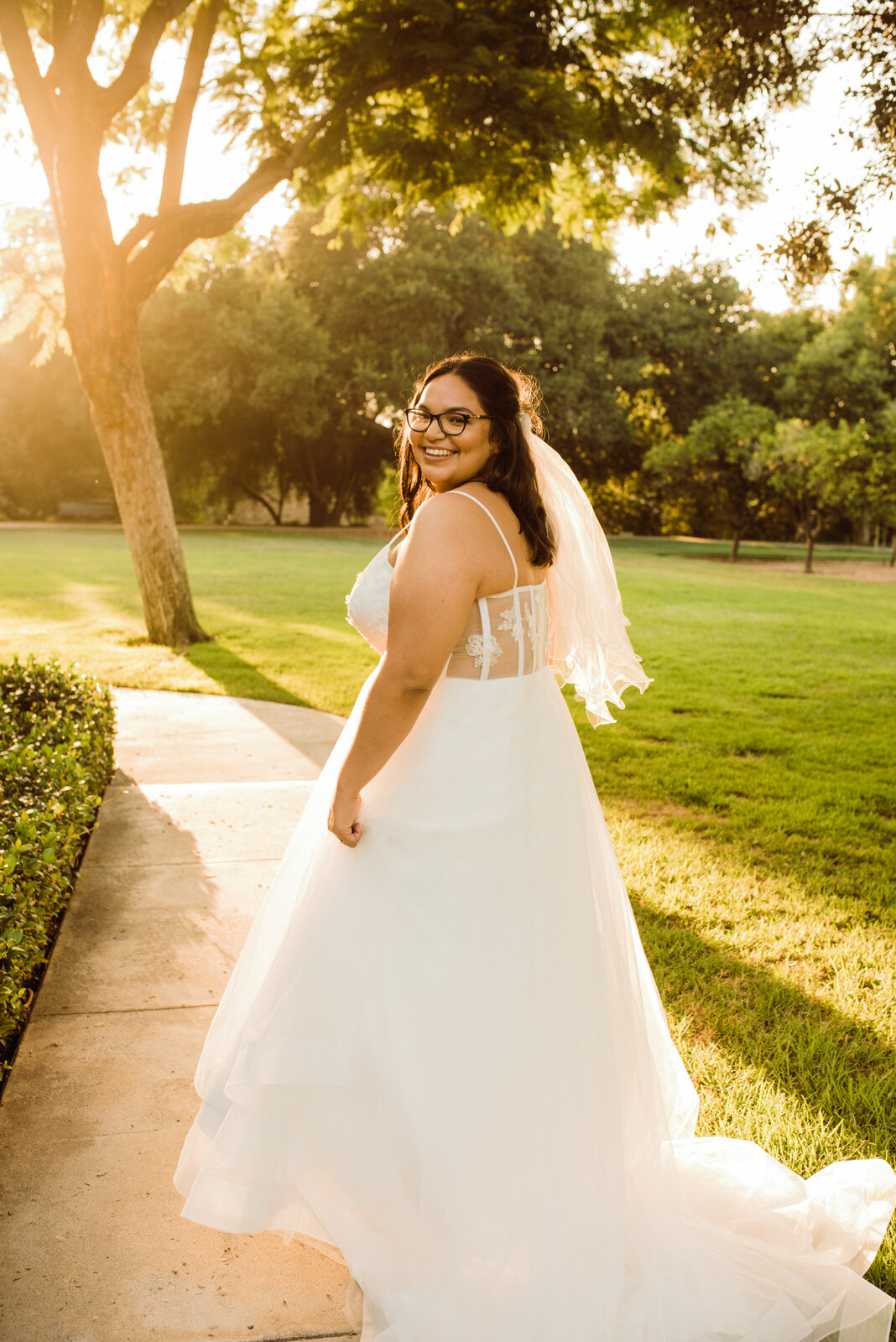 Backlit sunny photo of bride in glasses at Heritage Park in Santa Fe Springs