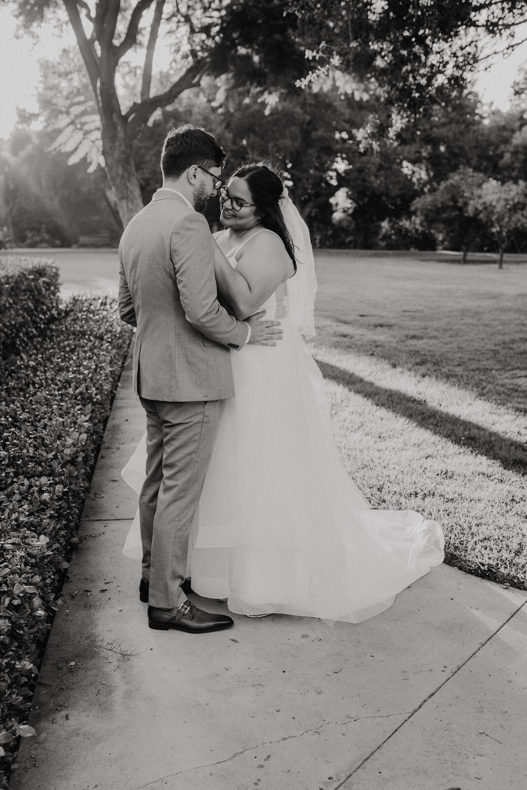 Black and white romantic photo of bride and groom on wedding day at Heritage Park