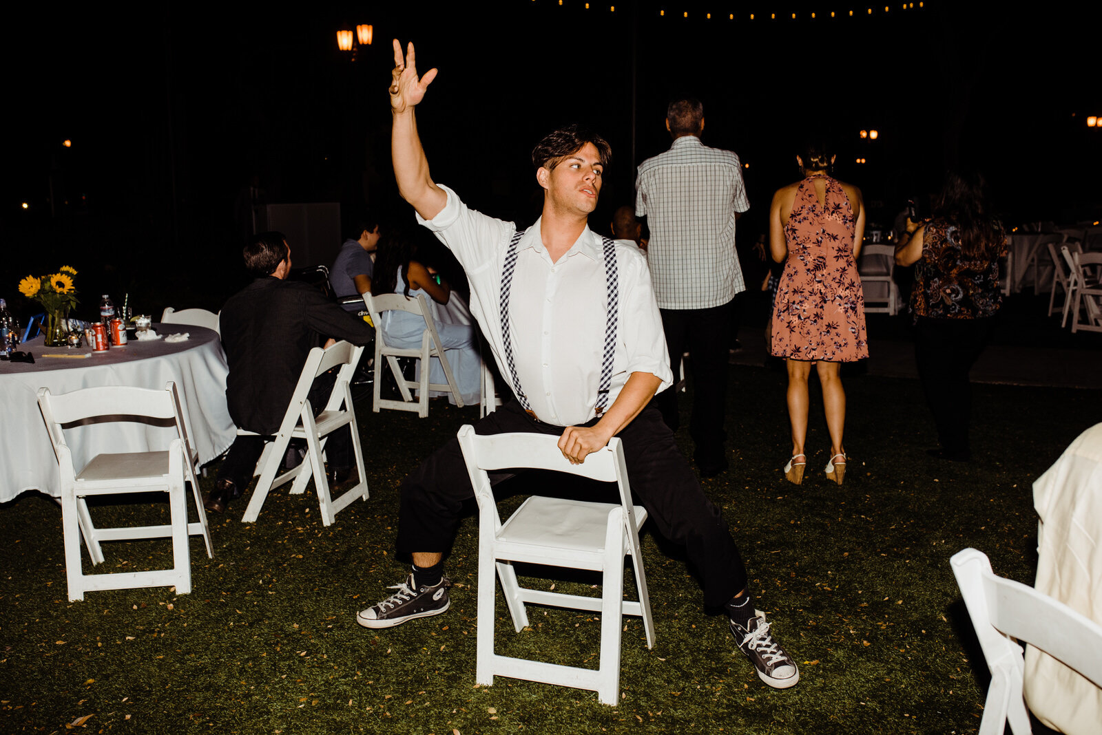 Man dancing on chair at Heritage Park wedding in Santa Fe Springs