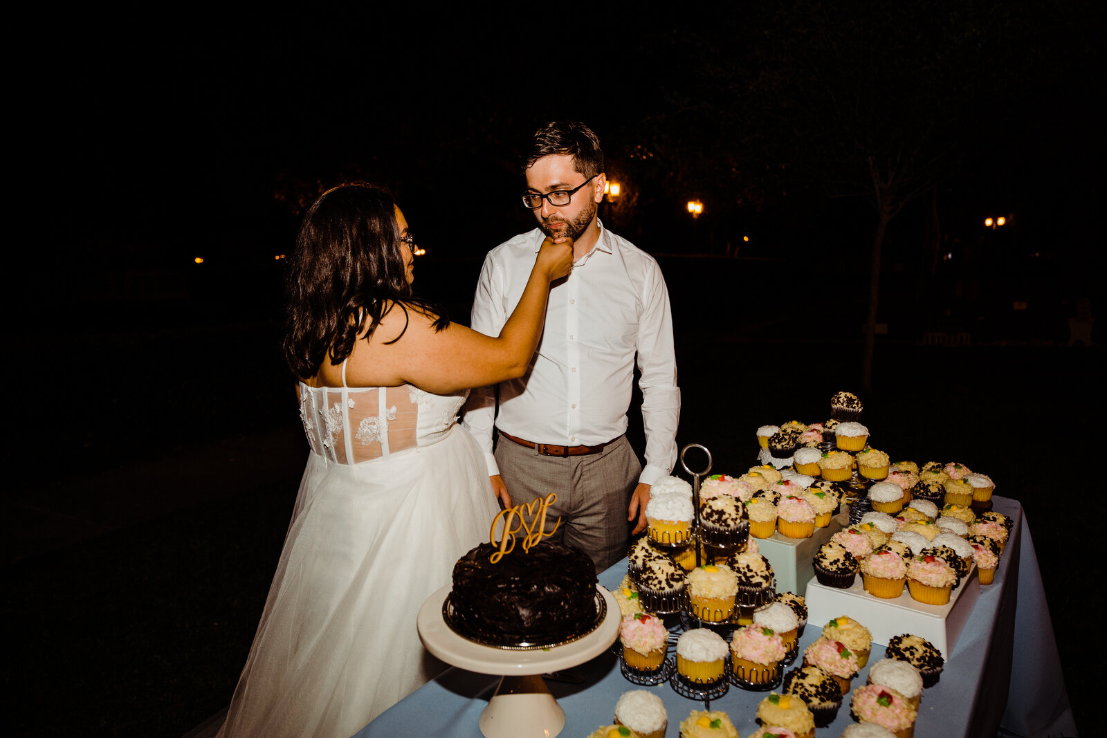 Bride and groom eat cake at Heritage Park in Santa Fe Springs