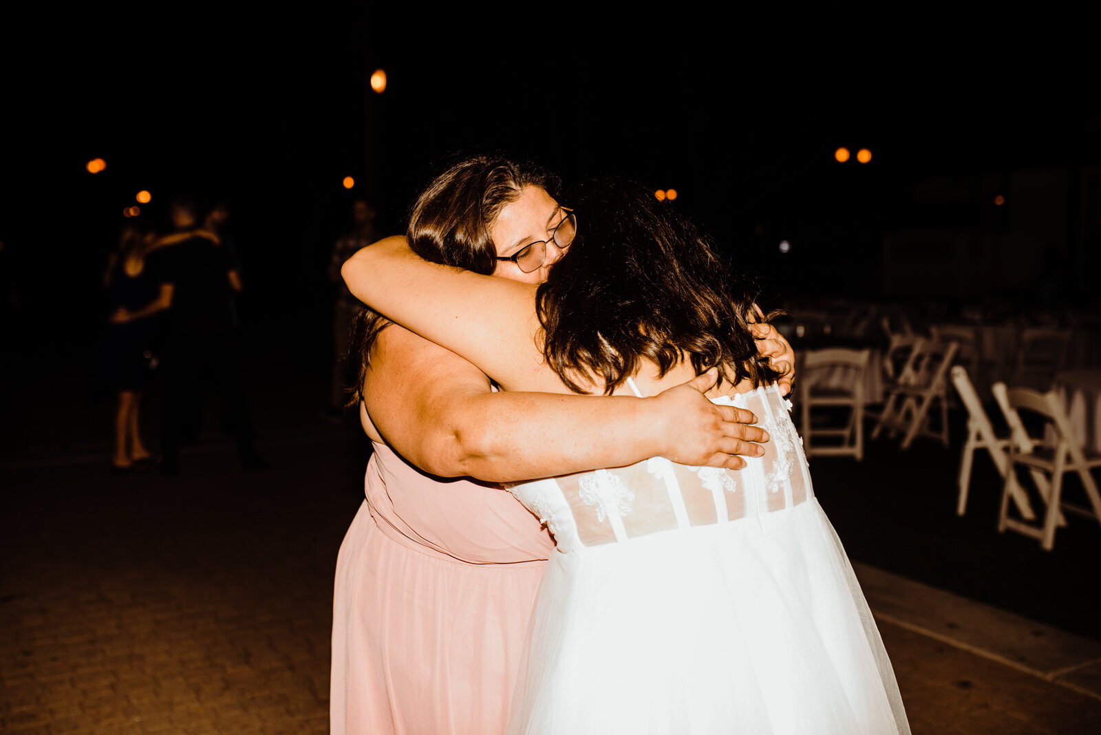 Mom and bride hug at Heritage Park summer wedding reception