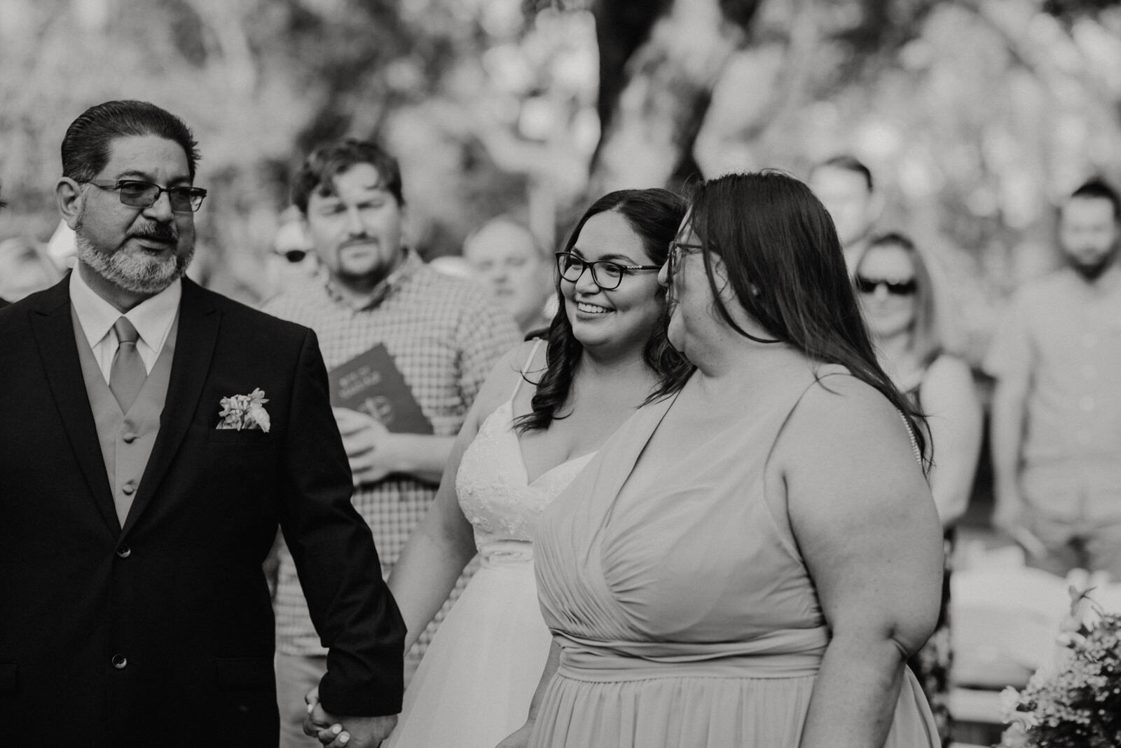 Bride walks with parents at Heritage Park wedding