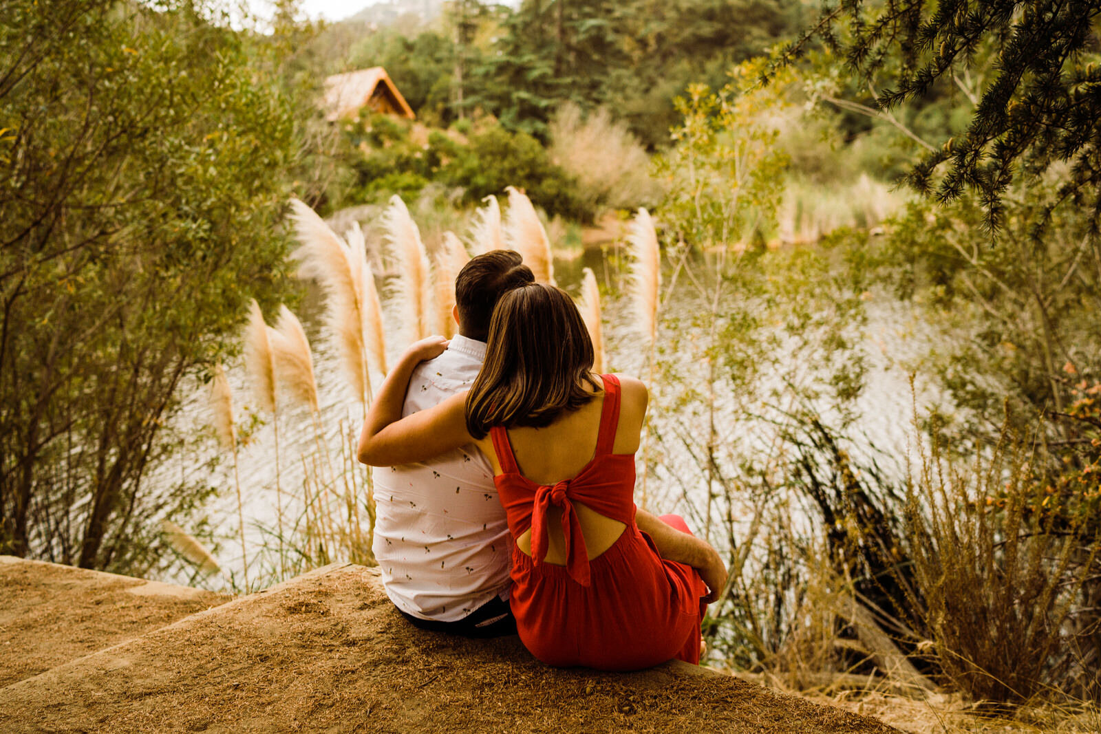 Couple at Franklin Canyon Park Reservoir in red jumpsuit