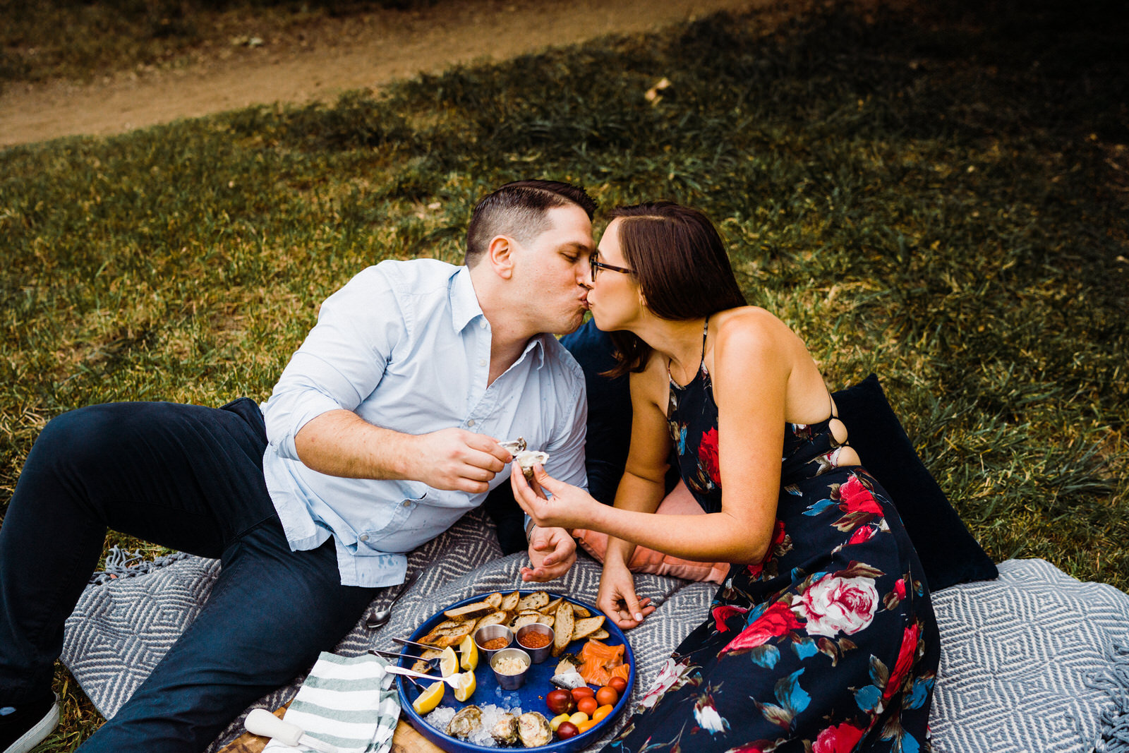 Couple kiss on blanket at Franklin Canyon Park Picnic Engagement photos