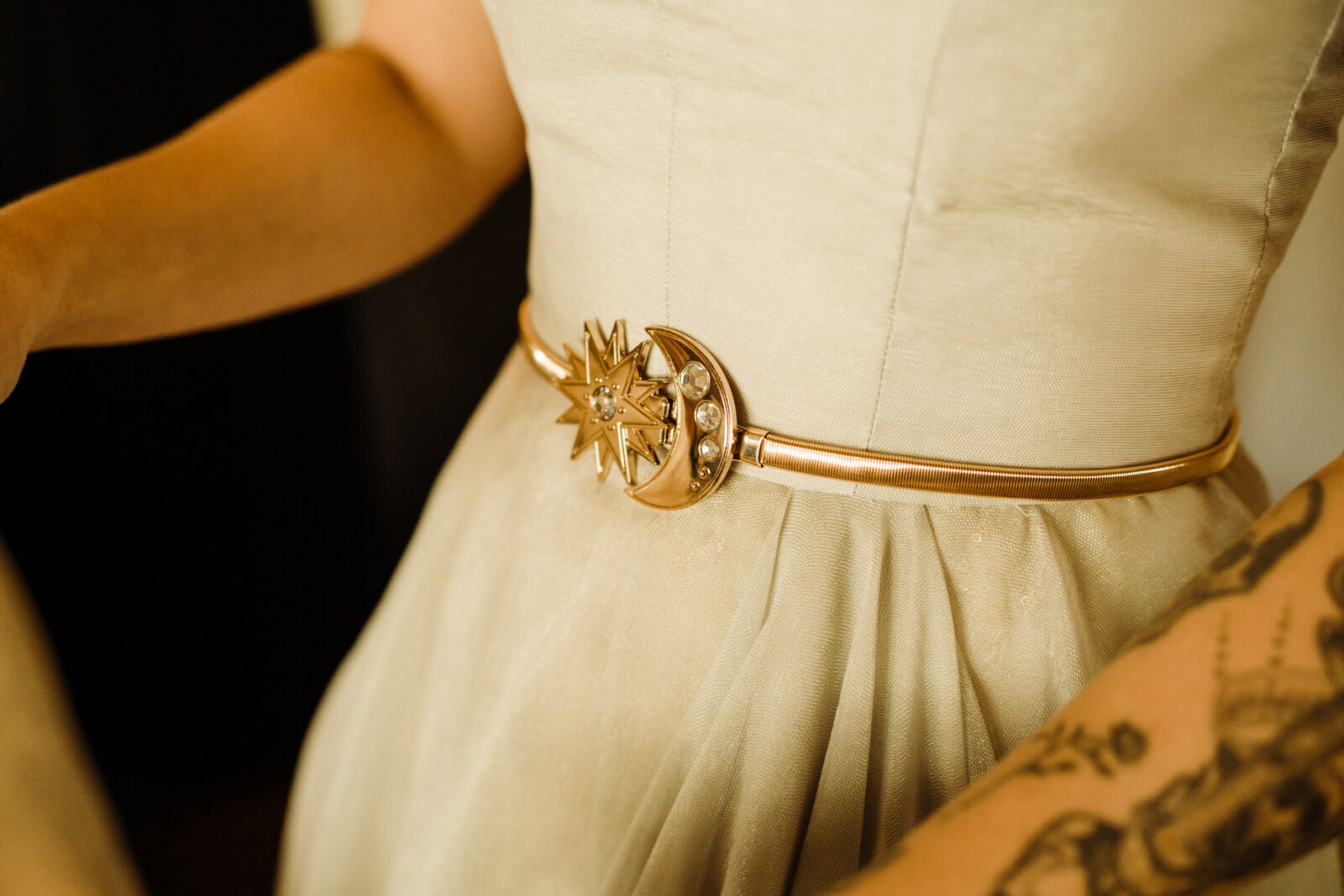 detail of sun and stars belt worn at modern, feminist wedding at Hotel Figueroa