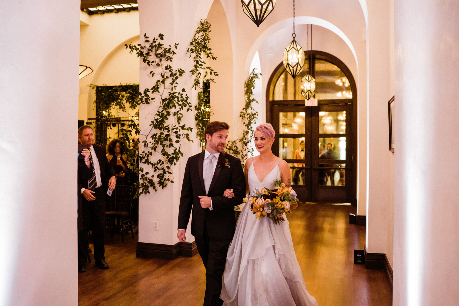 Couple enters together at modern, feminist, unique Hotel Figueroa wedding