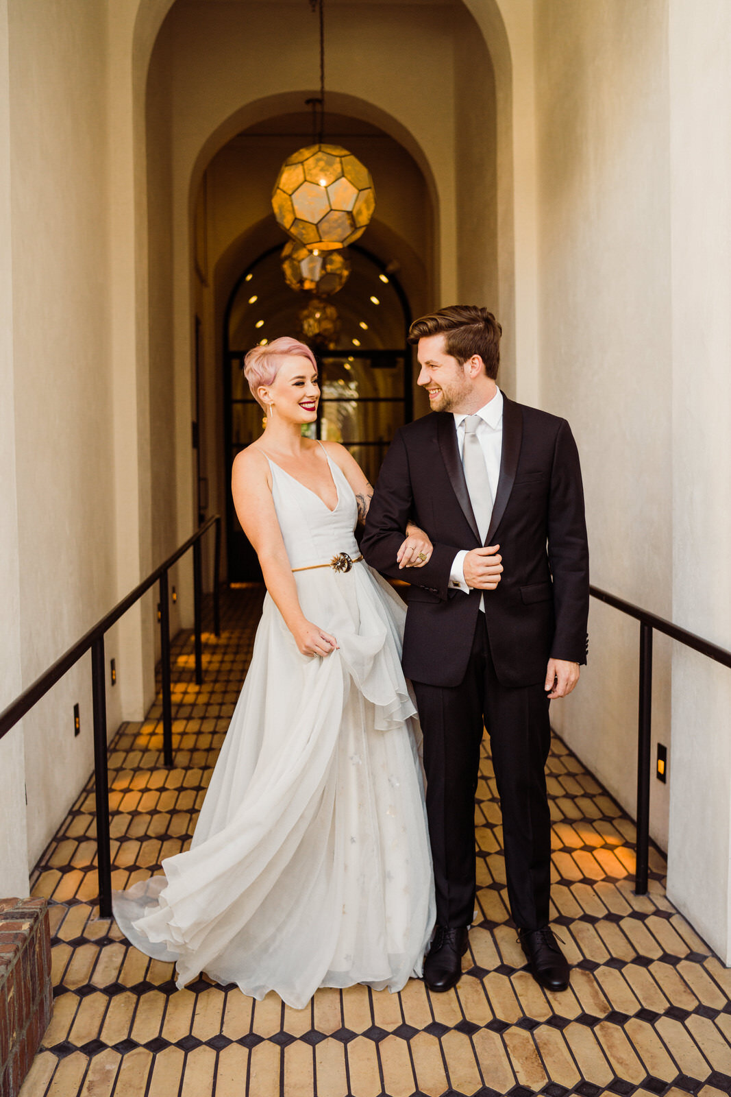 Playful, fun candids of modern, feminist couple at Hotel Figueroa wedding