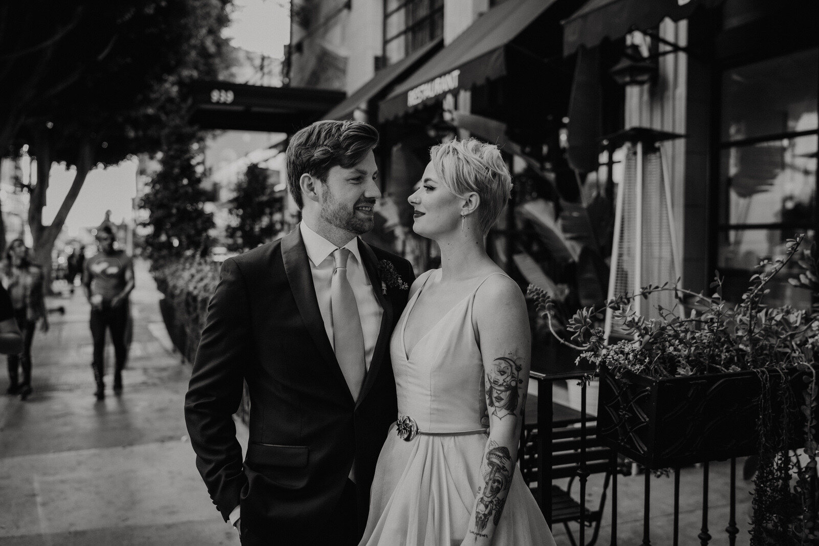 black and white romantic photo of couple in front of Hotel Figueroa for feminist, modern, unique wedding