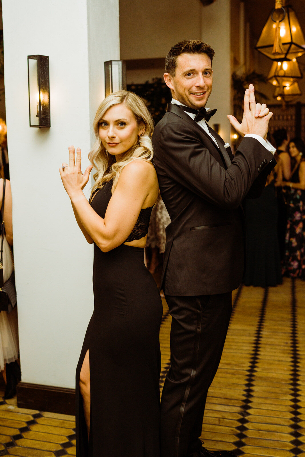 Couple poses as Charlie's Angels at cocktail hour at The Veranda Hotel Figueroa