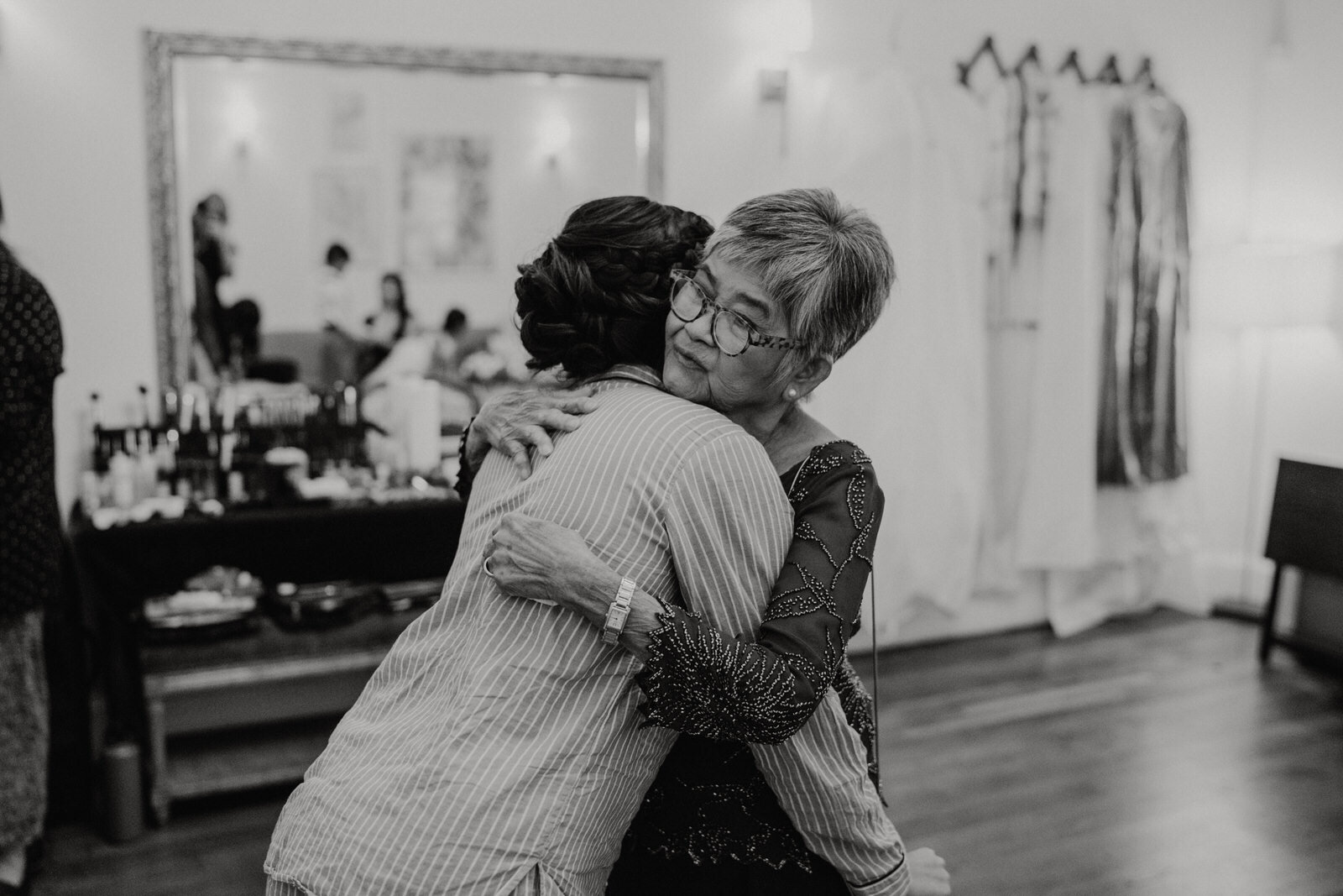 Bride hugging grandmother at at Franciscan Gardens wedding in San Juan Capistrano, CA by Kept Record www.keptrecord.com