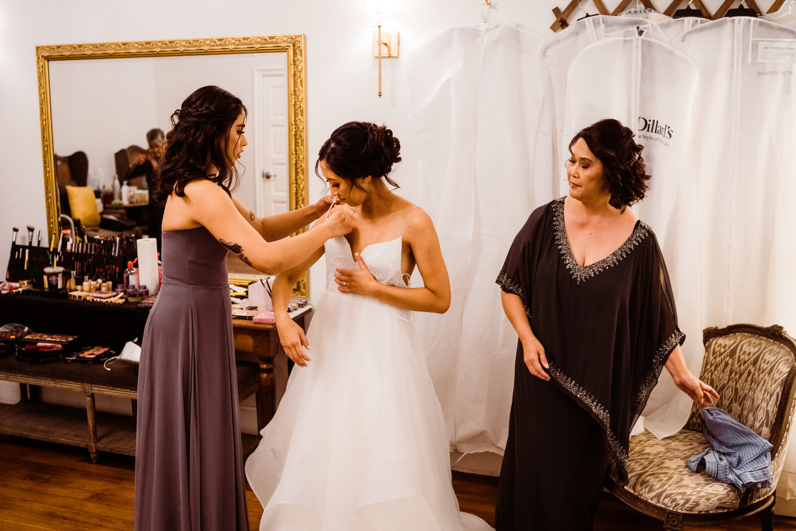 Bride getting dressed at Franciscan Gardens wedding in San Juan Capistrano, CA by Kept Record www.keptrecord.com