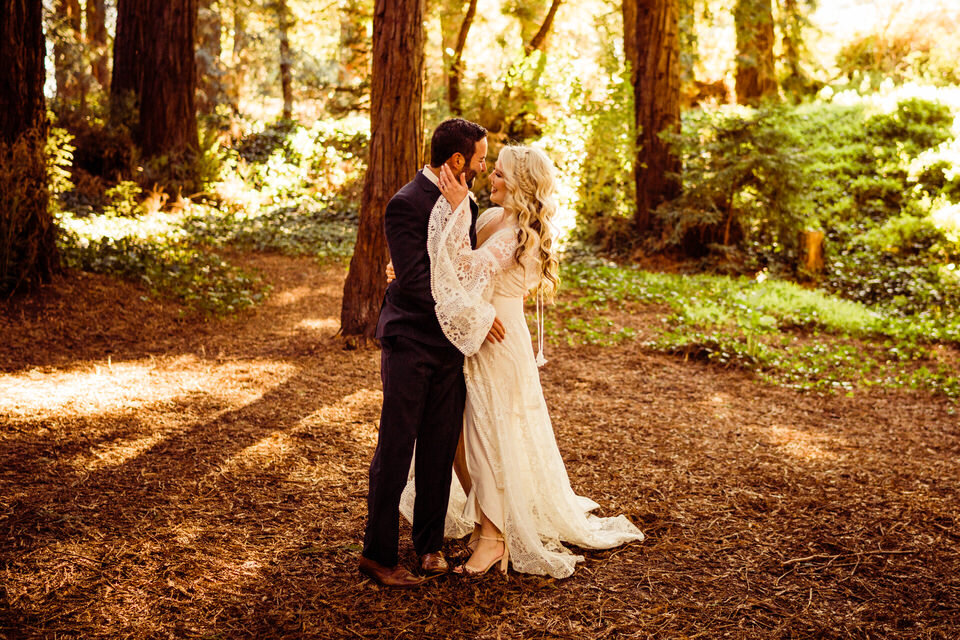 Bride and groom dance beneath Redwoods in boho elopement