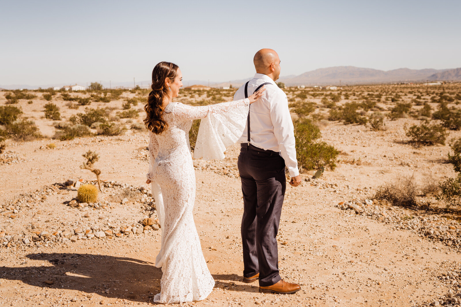 Elopement bride taps groom's shoulder during first look in Joshua Tree | photo by Kept Record | www.keptrecord.com