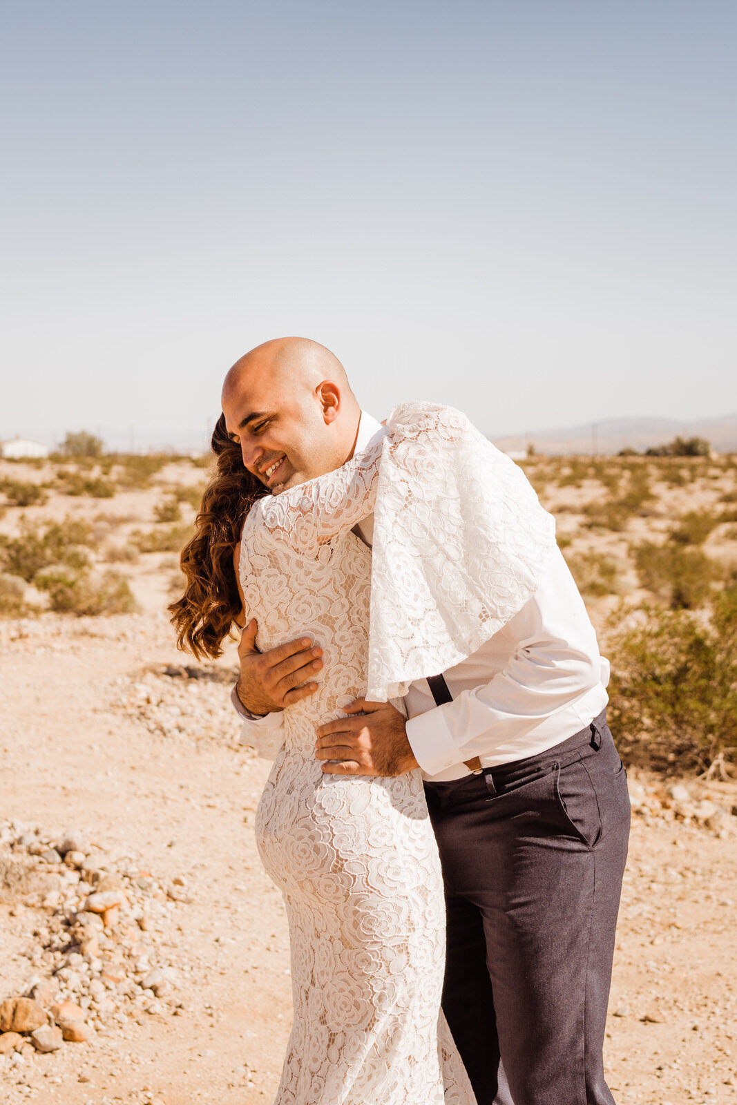 Groom hugs bride in Joshua Tree | photo by Kept Record | www.keptrecord.com