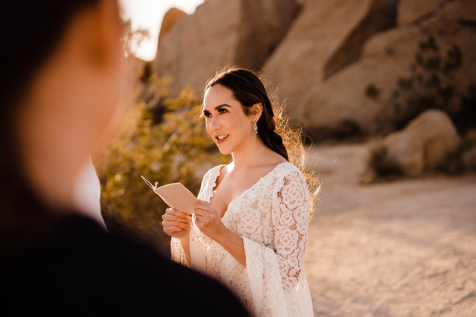 Bride reads vows to groom at Joshua Tree elopement ceremony | planning an elopement | adventurous, fun, warm wedding photos by Kept Record | www.keptrecord.com