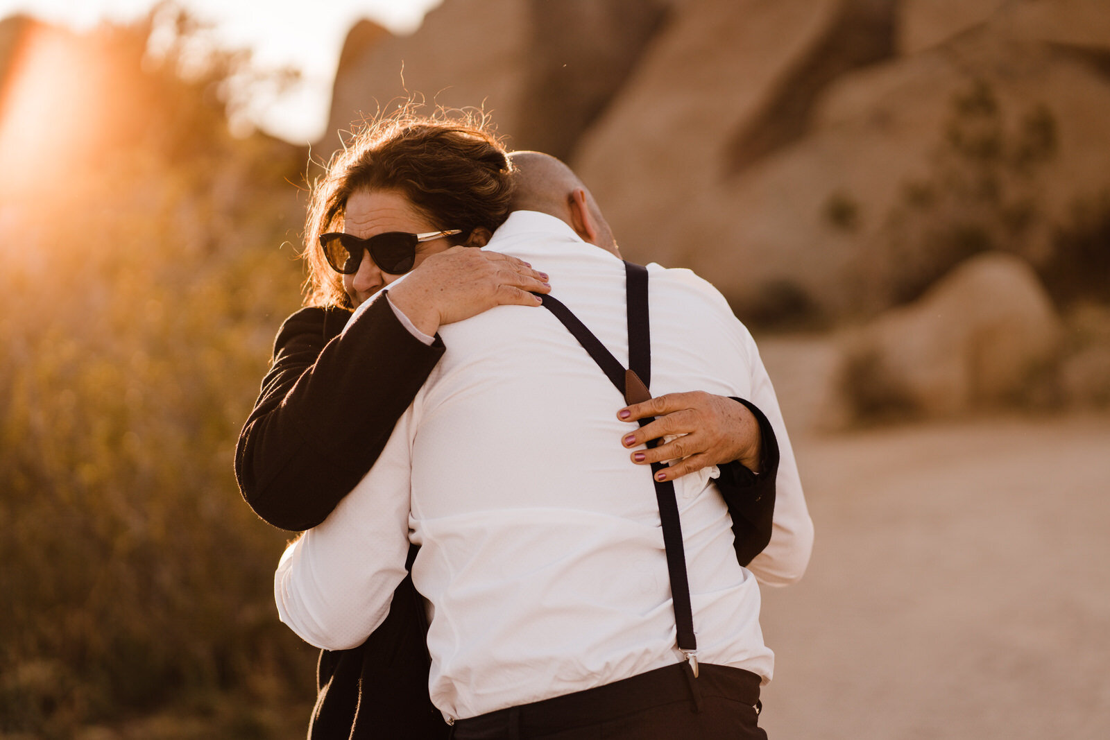 Groom Piero and his mother hug emotionally after Live Oak Picnic Area wedding in Joshua Tree elopement | adventurous, fun, warm wedding photos by Kept Record | www.keptrecord.com