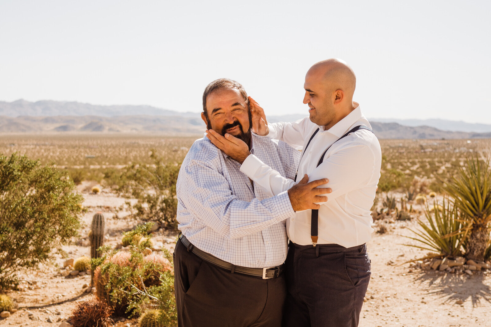 Groom and father of the groom laughing at Cactus Mountain Retreat before elopement in Joshua Tree | adventurous, fun, warm wedding photos by Kept Record | www.keptrecord.com