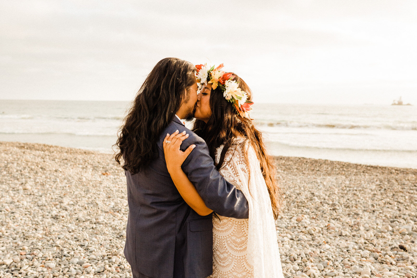 Bride and groom kiss on San Clemente beach