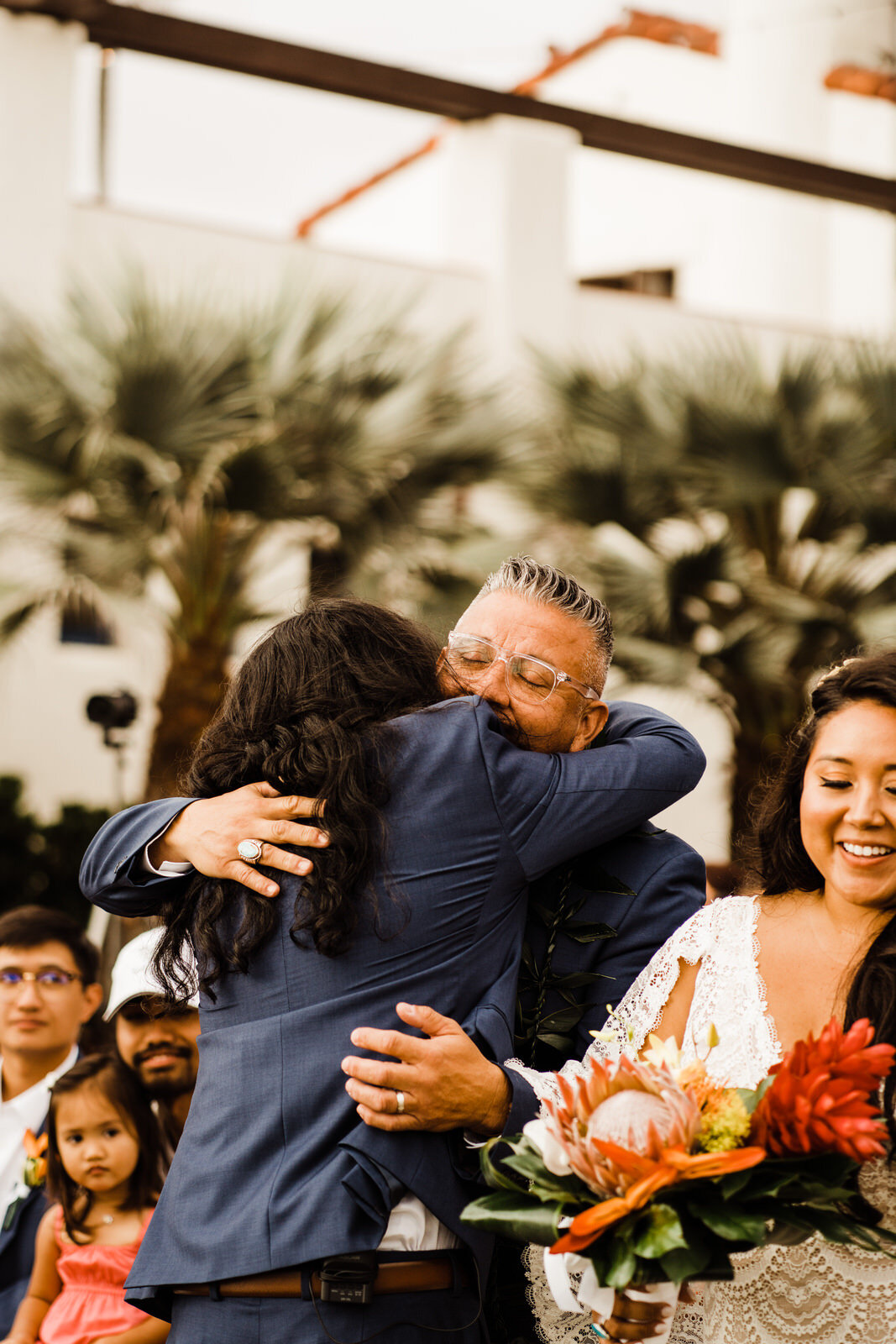 ole-hanson-beach-club-wedding-father-hugs-groom.jpg