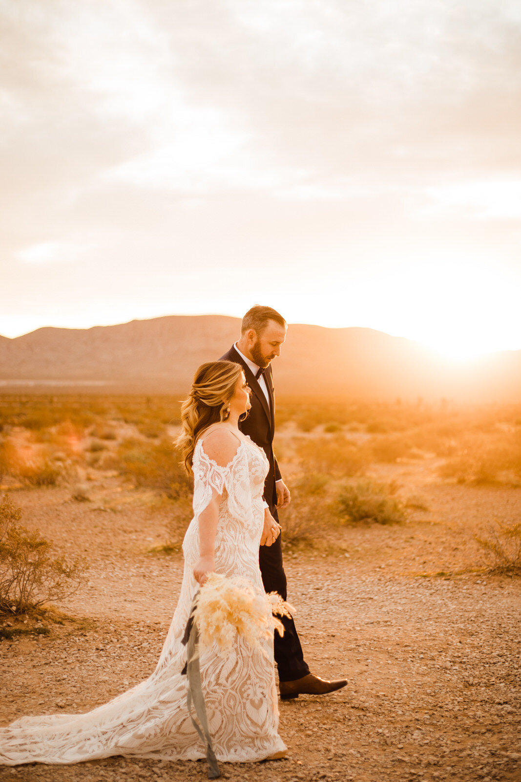 Las-Vegas-Wedding-Seven-Magic-Mountains-First-Look-Bride-and-Groom-walking-in-desert.JPG