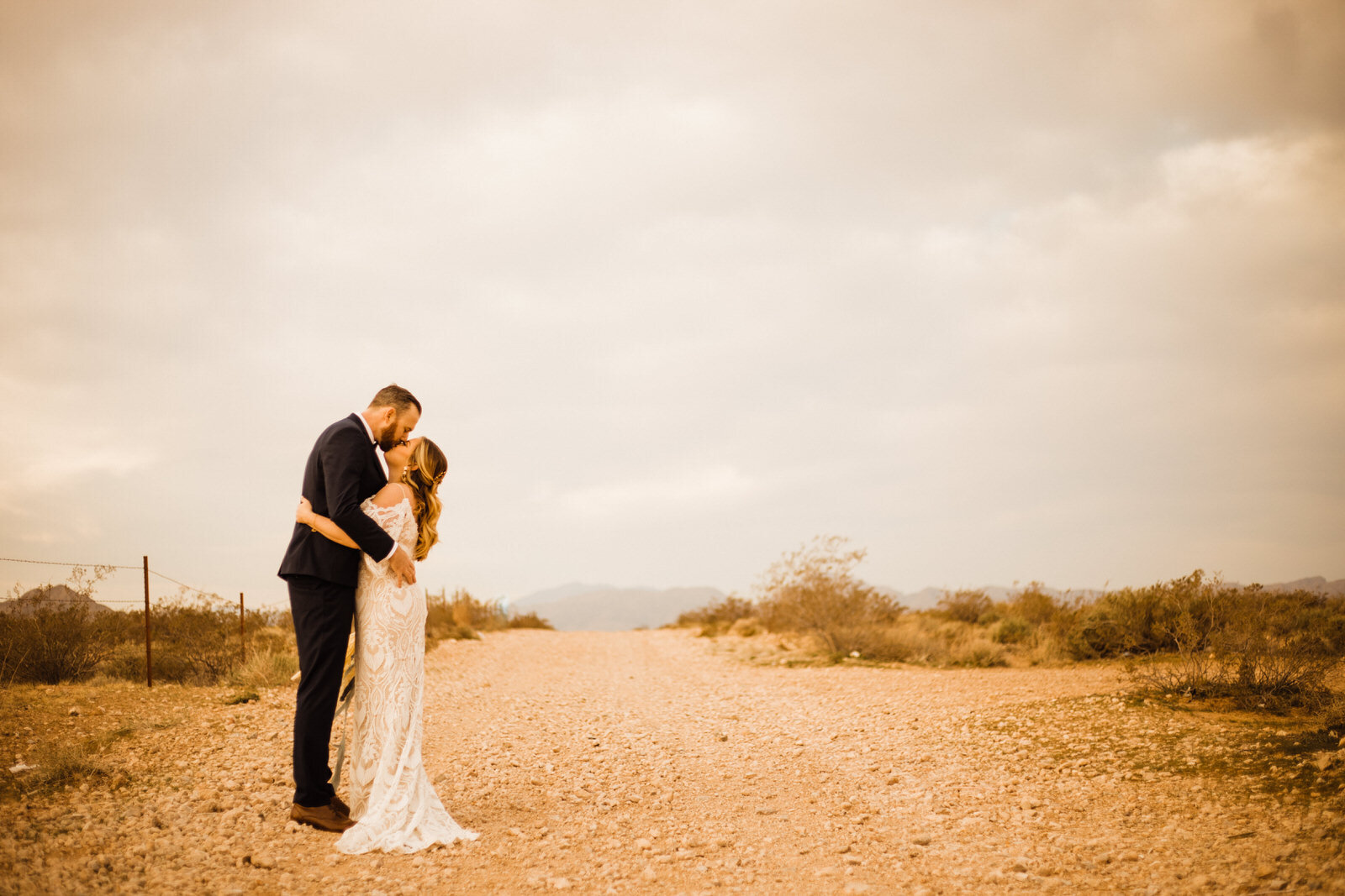 Las-Vegas-Wedding-Bride-And-Groom-Kiss-On-Dirt-Road-in-Nevada-Desert.JPG