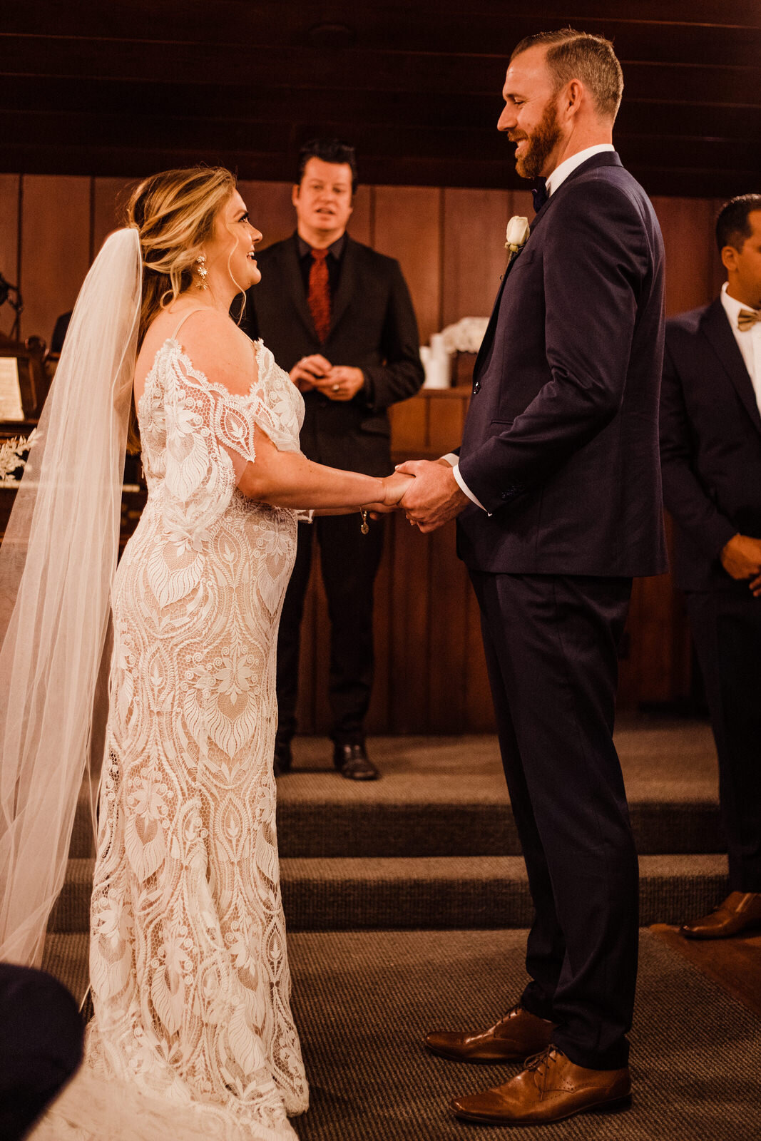 Bride and Groom hold hands during Las Vegas Little Church of the West Wedding Ceremony