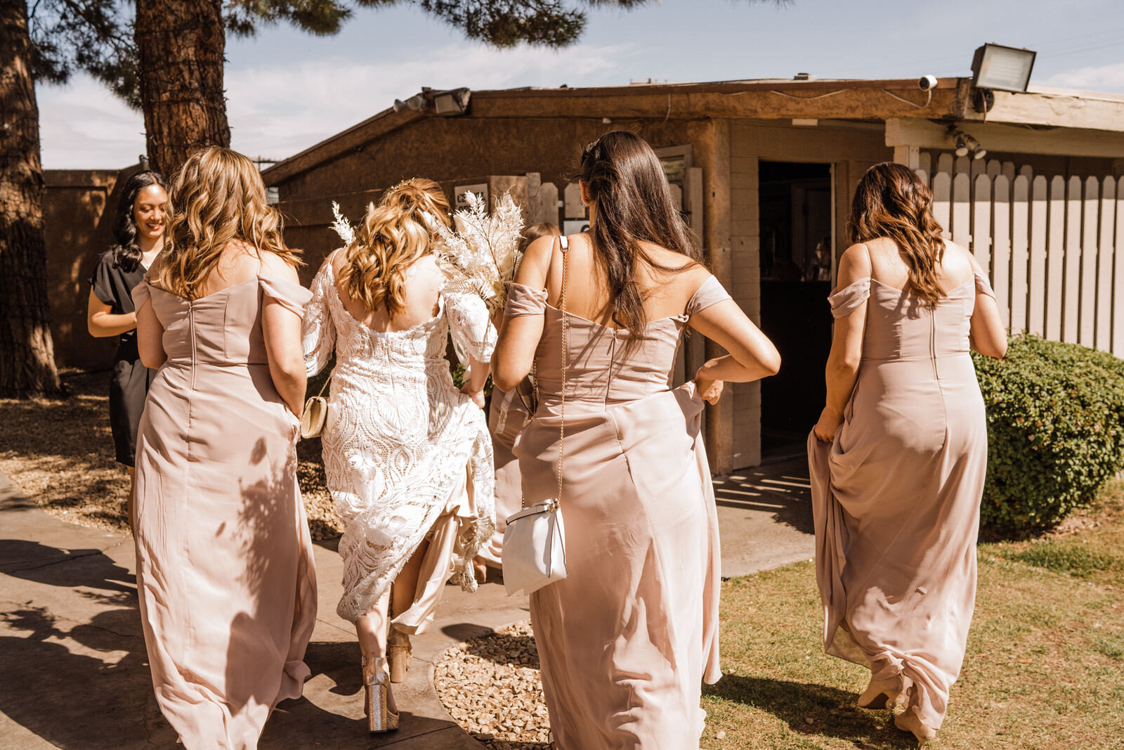 Candid photo of bridesmaids and bride walking at Little Church of the West wedding venue in Las Vegas, NV