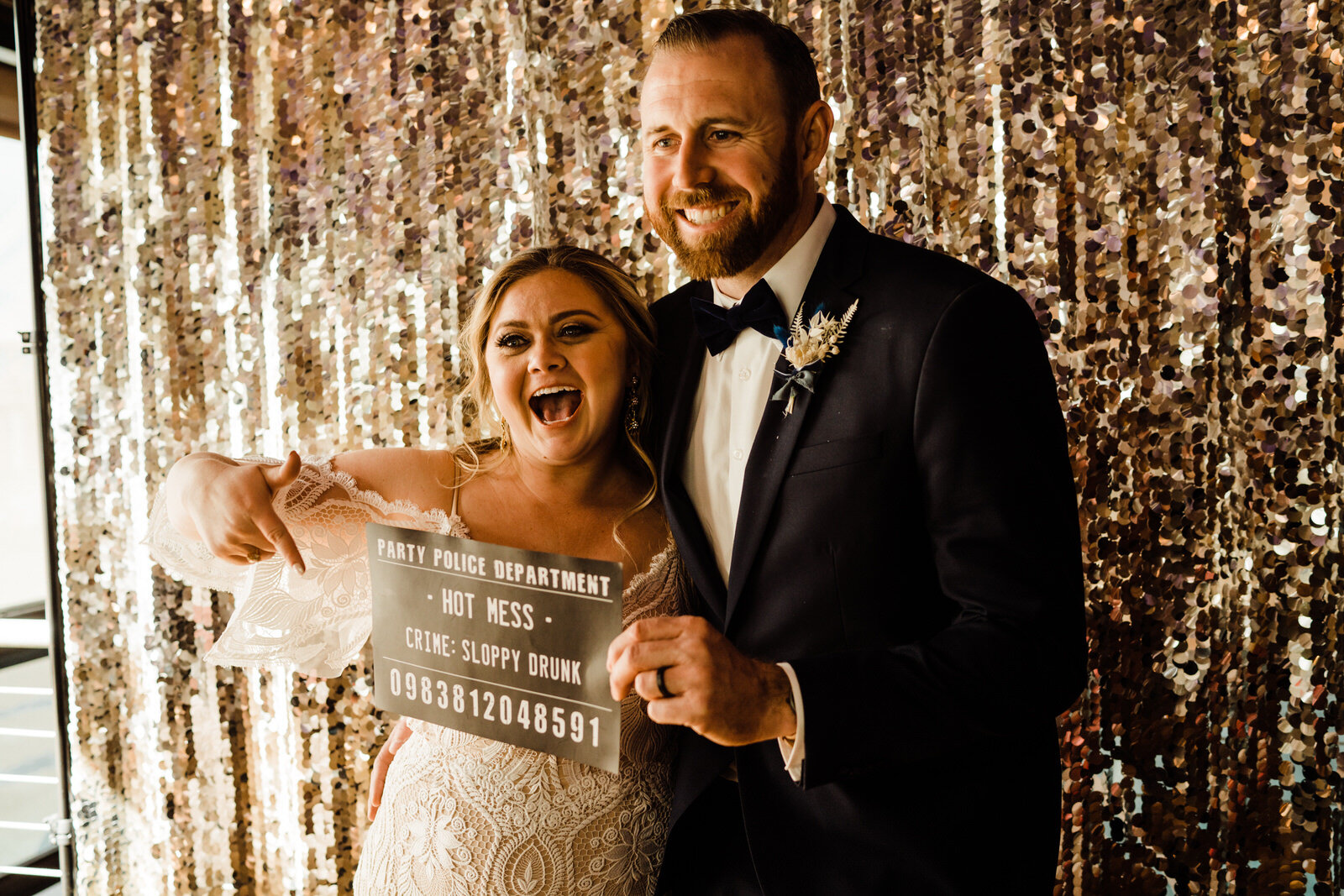 Bride and Groom in photobooth with sign at Las Vegas wedding reception at Margaritaville