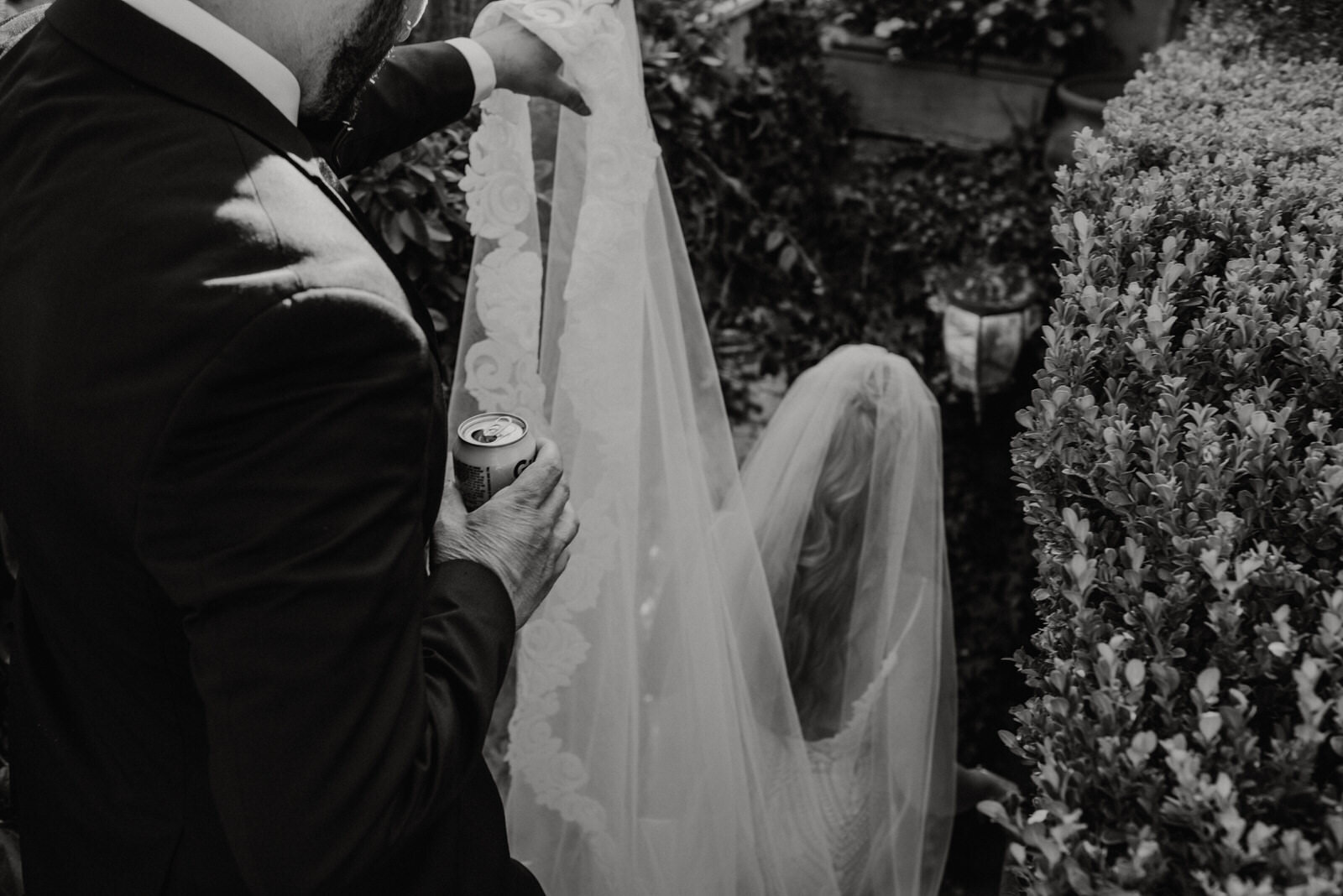 Documentary photo groom holding veil and beer | fun, nontraditional wedding photos by California Elopement Photographer Planner Kept Record | www.keptrecord.com