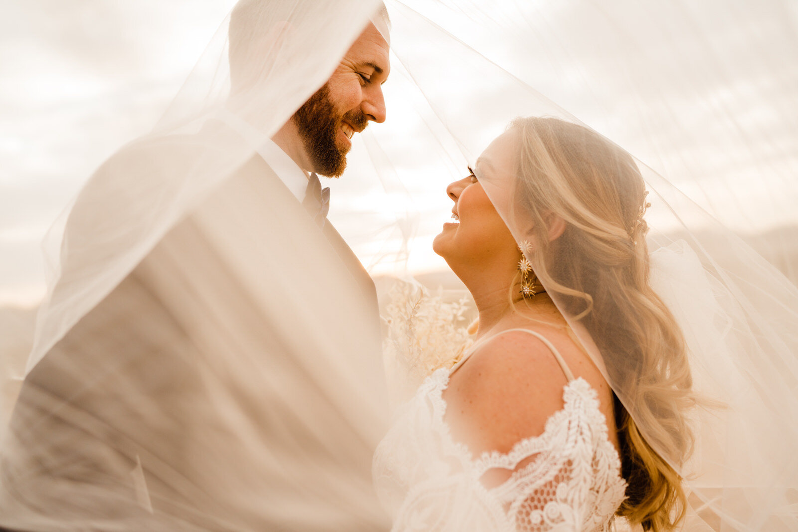 Tall groom and short bride beneath veil at Las Vegas destination wedding | fun, nontraditional wedding photos by California Elopement Photographer Planner Kept Record | www.keptrecord.com