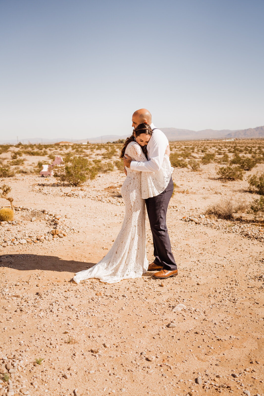 First look at sunny Joshua Tree elopement | groom in suspenders | Joshua Tree Lulu's wedding dress | photos by California Elopement Photographer Planner Kept Record | www.keptrecord.com